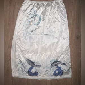 Y2K white silk midi skirt with dolphin and bubble detail.